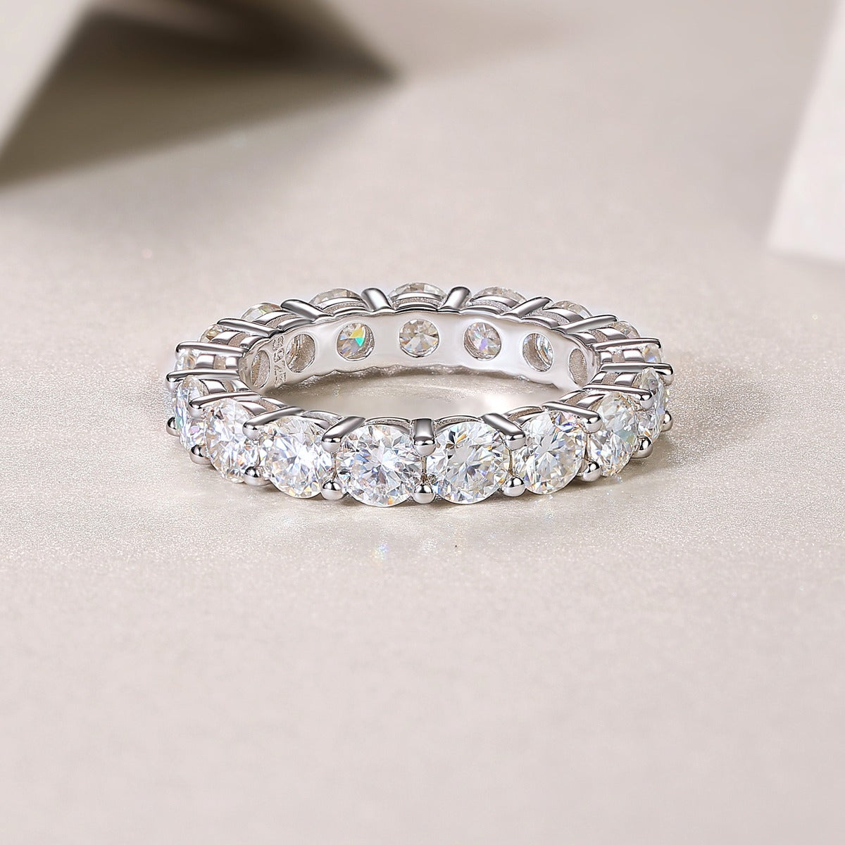 Silver ring with multiple diamonds on a light background خاتم تنس موزونايت فضه بدل الالماس